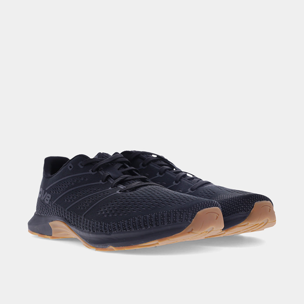 Pair of INOV8 F-Fly training shoes, black and gum, angled view